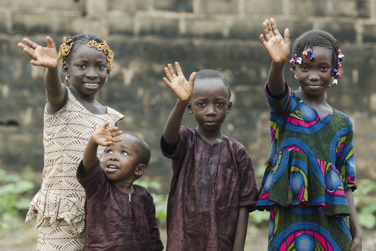 Enfants d'une communauté accompagnée par HAMAP-Humanitaire, saluant l'équipe sur le terrain.